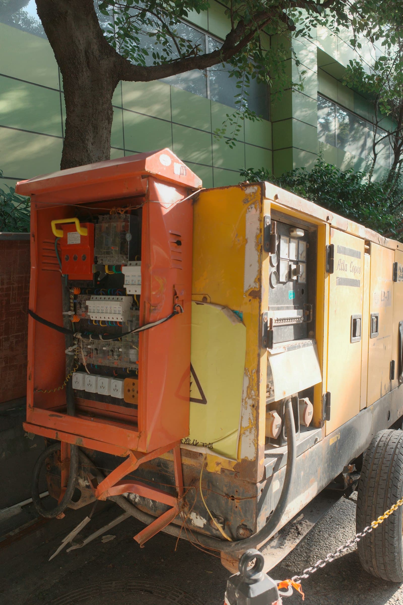 Industrial generator set with its control panel open.