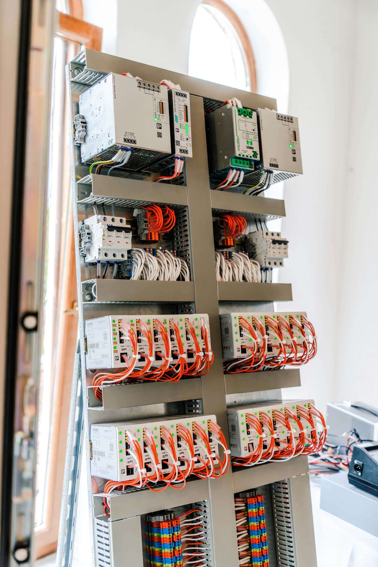 Power supplies, relays and terminals mounted in a cabinet.