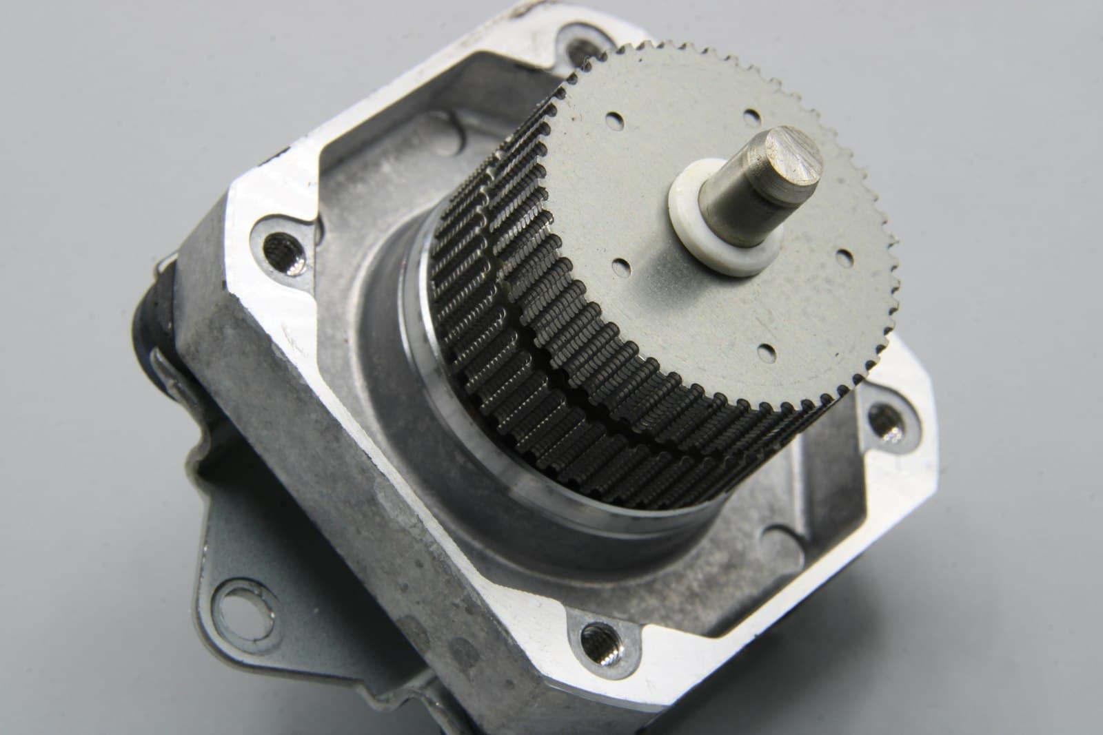 Servo motor with gearhead on a bench.