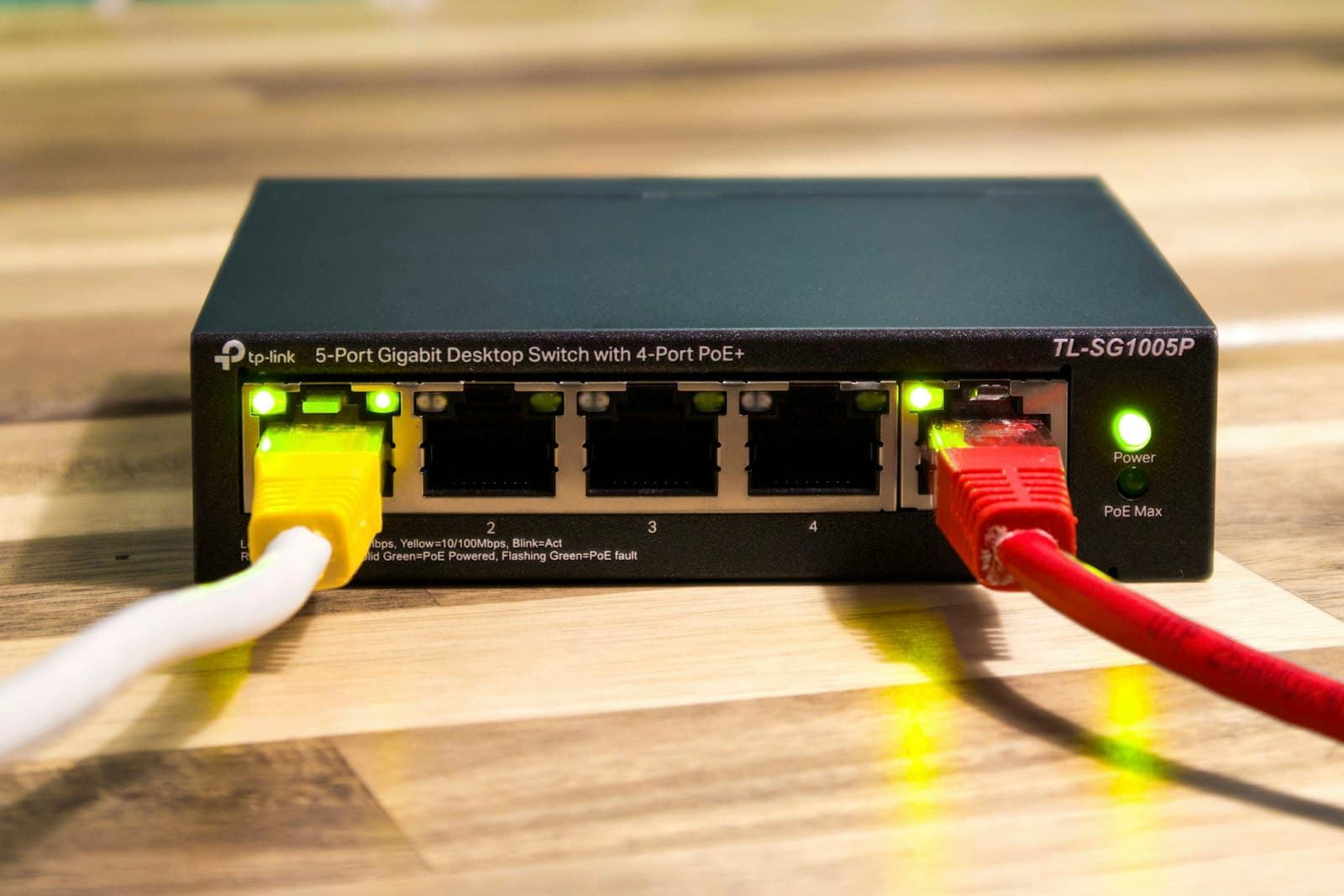 Unmanaged Ethernet switch with network cables connected.