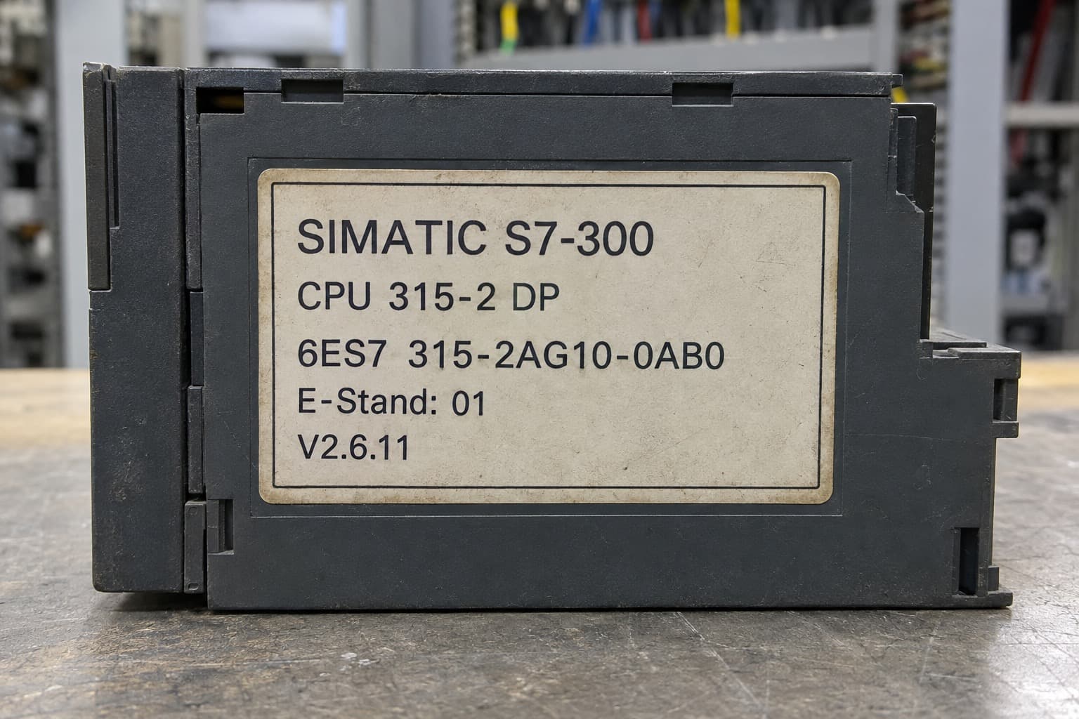 Illustration of an S7-300 CPU 315-2 DP side label showing an order number, a hardware version and a firmware version
